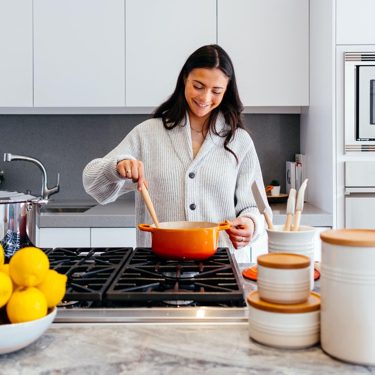 woman cooking in her kitchen food trends
